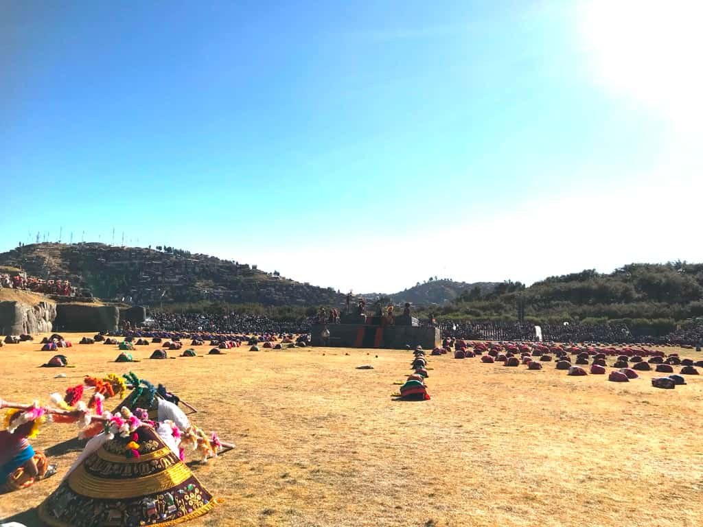 The wide grass plaza of Saqsaywaman becomes a field of reverence under a bright sun on Inti Raymi.